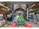 Interior view of a garage with a car lift, lawnmower and extensive storage at 2921 Lake Tohopekaliga Blvd, Kissimmee, FL 34746
