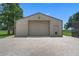 Exterior of a large metal garage with matching doggie door and brick pavers at 2921 Lake Tohopekaliga Blvd, Kissimmee, FL 34746