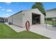 Large detached garage with open bay, concrete driveway, and well-maintained lawn at 2921 Lake Tohopekaliga Blvd, Kissimmee, FL 34746
