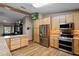 Modern kitchen with stainless steel appliances, wood cabinets, and hardwood flooring at 2921 Lake Tohopekaliga Blvd, Kissimmee, FL 34746