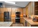 Well-lit kitchen featuring stainless steel appliances, wood cabinets, and countertop space at 2921 Lake Tohopekaliga Blvd, Kissimmee, FL 34746