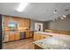 Open kitchen with wood cabinets, granite countertops, stainless steel appliances, and a view of the backyard at 2921 Lake Tohopekaliga Blvd, Kissimmee, FL 34746
