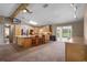 Open kitchen with wood cabinets, granite countertops, bar seating, and a view of the pool at 2921 Lake Tohopekaliga Blvd, Kissimmee, FL 34746