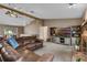 Spacious living room features a leather couch, entertainment center, and adjacent dining area at 2921 Lake Tohopekaliga Blvd, Kissimmee, FL 34746
