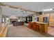 Open concept living space with fireplace, TV, and kitchen with bar seating at 2921 Lake Tohopekaliga Blvd, Kissimmee, FL 34746