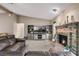 Cozy living room with brick fireplace, vaulted ceilings, and comfortable leather seating at 2921 Lake Tohopekaliga Blvd, Kissimmee, FL 34746
