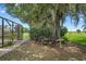 Cozy patio seating area shaded by a mature tree and beautiful landscaping at 2921 Lake Tohopekaliga Blvd, Kissimmee, FL 34746