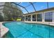 Beautiful pool with seating inside of screen enclosure; a perfect outdoor retreat at 2921 Lake Tohopekaliga Blvd, Kissimmee, FL 34746