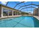 Sparkling pool in screened enclosure offering serene views and easy access to the indoors at 2921 Lake Tohopekaliga Blvd, Kissimmee, FL 34746