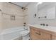 Well-lit bathroom featuring a shower-tub combo with stylish tile accents and a wooden vanity at 3015 Riviera Bay Ct, Oviedo, FL 32765