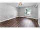 Bright bedroom with wood floors, a window overlooking the yard, and a mirrored closet at 3015 Riviera Bay Ct, Oviedo, FL 32765