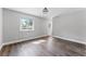 Comfortable bedroom featuring a window with palm tree views and wood flooring at 3015 Riviera Bay Ct, Oviedo, FL 32765