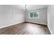 Bright bedroom featuring a chandelier, wood flooring, and a sunlit window at 3015 Riviera Bay Ct, Oviedo, FL 32765