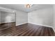 Clean bedroom featuring a mirrored closet, modern light fixture, and wood-look laminate flooring at 3015 Riviera Bay Ct, Oviedo, FL 32765