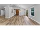 Spacious dining area featuring wood-look floors, modern lighting, and a rustic barn door at 3015 Riviera Bay Ct, Oviedo, FL 32765