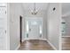 Bright and airy foyer featuring hardwood floors, updated lighting, and a classic entry door at 3015 Riviera Bay Ct, Oviedo, FL 32765