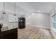 Bright, open kitchen featuring modern lighting, wood floors, and stainless steel refrigerator at 3015 Riviera Bay Ct, Oviedo, FL 32765