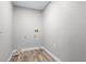 Small, unfinished laundry room with wood flooring, utility hookups, and white walls at 3015 Riviera Bay Ct, Oviedo, FL 32765