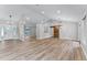 Open-concept living room featuring vaulted ceilings, modern lighting, and a rustic barn door at 3015 Riviera Bay Ct, Oviedo, FL 32765