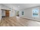 Bright living room with luxury vinyl floors, a barn door accent, and French doors to the pool at 3015 Riviera Bay Ct, Oviedo, FL 32765