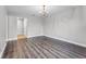 Spacious living room with decorative chandelier, and pristine white walls at 3015 Riviera Bay Ct, Oviedo, FL 32765