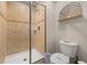 Neutral bathroom featuring a glass enclosed shower and toilet with wall decor at 3061 Beach Palm Ave, Kissimmee, FL 34747