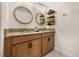 Bathroom featuring a double vanity, granite countertops, and round mirrors with decorative lighting at 3061 Beach Palm Ave, Kissimmee, FL 34747
