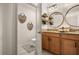 Stylish bathroom boasts a dual sink vanity, granite countertops, and rustic-chic wall decor at 3061 Beach Palm Ave, Kissimmee, FL 34747