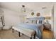 A spacious bedroom with an upholstered headboard, soft lighting, decorative wall art, and an area rug at 3061 Beach Palm Ave, Kissimmee, FL 34747
