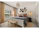 Bright bedroom with a large window, stylish decor, and comfortable furnishings at 3061 Beach Palm Ave, Kissimmee, FL 34747