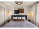 Bright bedroom with a large decorative headboard, ambient lighting, and a wall tapestry at 3061 Beach Palm Ave, Kissimmee, FL 34747