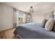 Bright bedroom with decorative wall art and comfortable soft furnishings, plus a large window and natural light at 3061 Beach Palm Ave, Kissimmee, FL 34747