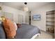 Modern bedroom featuring a cozy bed, tv, and woven light fixture at 3061 Beach Palm Ave, Kissimmee, FL 34747