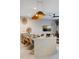 Stylish dining area with a unique pendant light, modern table with seating for eight, and sleek design at 3061 Beach Palm Ave, Kissimmee, FL 34747