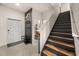 Inviting entryway with coat rack, leading to stairs and a glimpse of the bathroom at 3061 Beach Palm Ave, Kissimmee, FL 34747