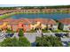 Colorful townhome exteriors with a central lake and parking area at 3061 Beach Palm Ave, Kissimmee, FL 34747