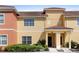 Charming townhome exterior featuring a well-manicured lawn and inviting front porch at 3061 Beach Palm Ave, Kissimmee, FL 34747