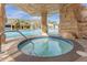 Inviting hot tub with waterfall feature and stone surround, set within a luxurious community pool area at 3061 Beach Palm Ave, Kissimmee, FL 34747