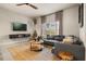 Cozy living room with a large sectional sofa, unique lighting fixtures, and contemporary decor at 3061 Beach Palm Ave, Kissimmee, FL 34747