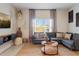 Comfortable living room featuring a plush gray sectional sofa and stylish decor at 3061 Beach Palm Ave, Kissimmee, FL 34747