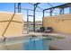 Outdoor pool featuring a raised spa area, lounge chairs, and a scenic view of the adjacent lake at 3061 Beach Palm Ave, Kissimmee, FL 34747
