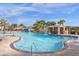 Resort-style community pool with a waterfall feature, palm trees, and easy access ladder at 3061 Beach Palm Ave, Kissimmee, FL 34747