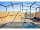 Outdoor pool area with comfortable lounge chairs and a tranquil view of the lake at 3061 Beach Palm Ave, Kissimmee, FL 34747