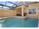Inviting outdoor pool with a covered lanai, a seating area and a built-in grill at 3061 Beach Palm Ave, Kissimmee, FL 34747