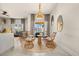 Inviting sitting area with four wicker chairs arranged around a rustic wooden table at 3061 Beach Palm Ave, Kissimmee, FL 34747