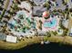 Stunning aerial view of resort-style community pools, lazy river, recreation areas, and lake at 3193 Pequod Pl, Kissimmee, FL 34746
