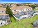 Aerial view of townhomes showing a screened-in pools and well-manicured lawn at 3193 Pequod Pl, Kissimmee, FL 34746