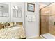 Bright bathroom featuring granite countertop, decorative art, and walk-in shower with tiled surround at 3193 Pequod Pl, Kissimmee, FL 34746