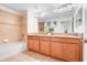 Bathroom showcasing double sinks, granite countertops, and a shower-tub combo at 3193 Pequod Pl, Kissimmee, FL 34746