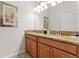 Bathroom features double sinks with granite countertops and wood cabinets underneath at 3193 Pequod Pl, Kissimmee, FL 34746